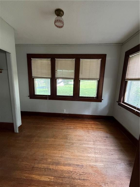 211 N Mulberry St, Maryville, MO 64468 - spare room featuring dark wood-type flooring and baseboards