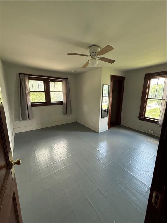 211 N Mulberry St, Maryville, MO 64468 - tiled spare room featuring ceiling fan and baseboards