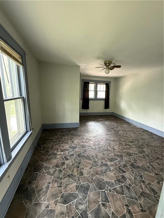 211 N Mulberry St, Maryville, MO 64468 - unfurnished room with stone floors, healthy amount of natural light, and a ceiling fan