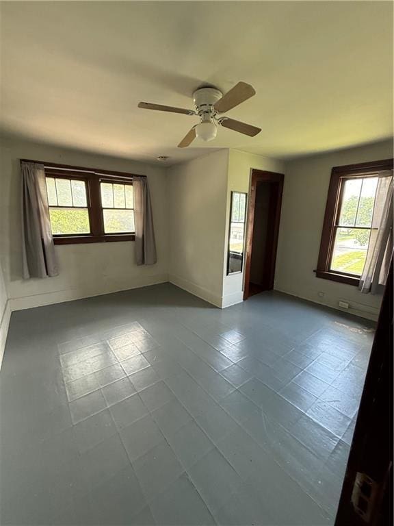 211 N Mulberry St, Maryville, MO 64468 - tiled empty room with a ceiling fan and baseboards