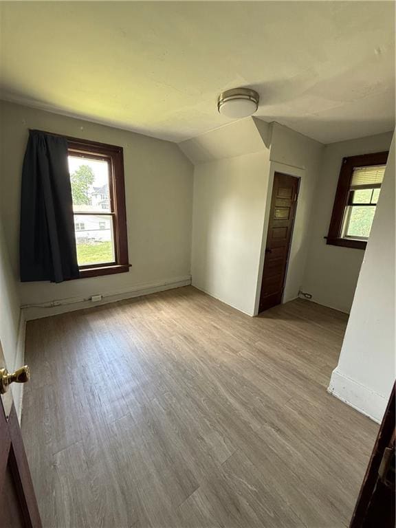 211 N Mulberry St, Maryville, MO 64468 - unfurnished room with wood finished floors and vaulted ceiling