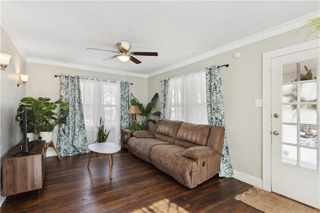 living room with ceiling fan, dark hardwood / wood-style flooring, and ornamental molding