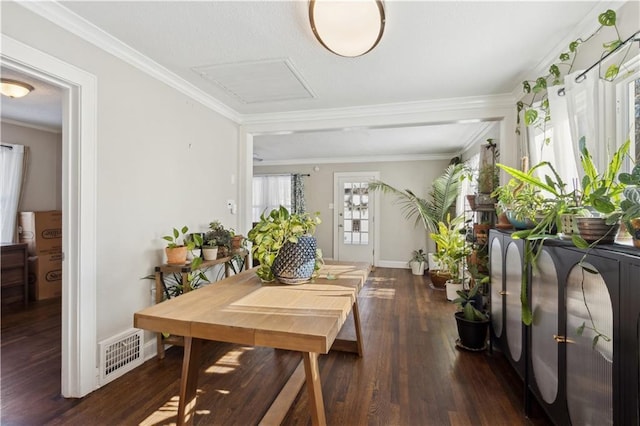 dining area featuring dark wood-type flooring and ornamental molding