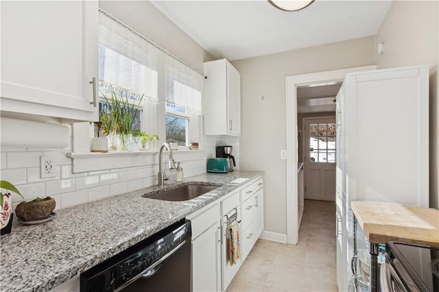 kitchen featuring dishwasher, white cabinetry, decorative backsplash, sink, and light stone counters