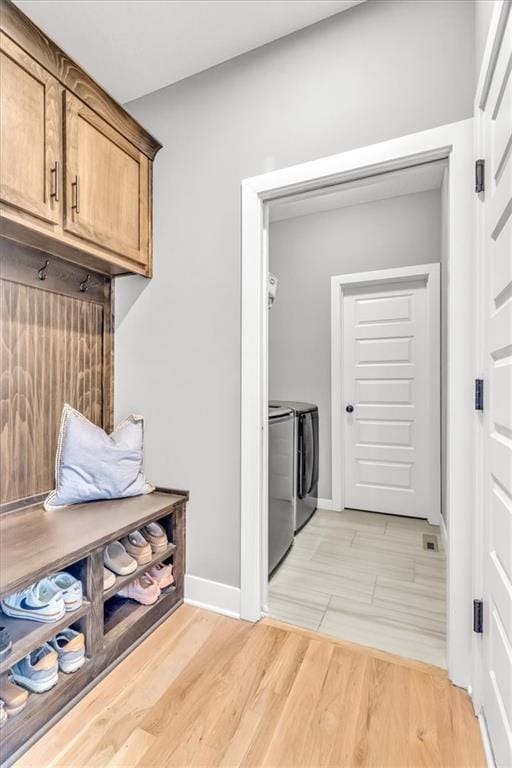 mudroom featuring light hardwood / wood-style flooring and washing machine and dryer