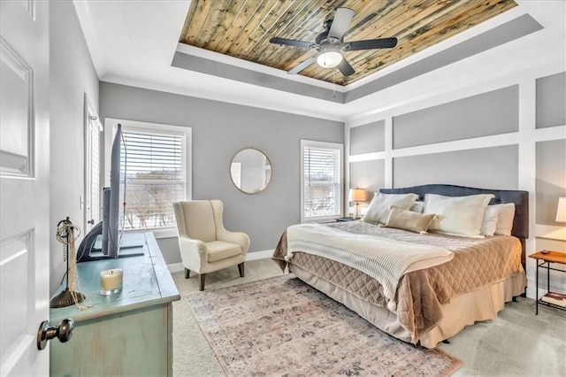 carpeted bedroom featuring a tray ceiling, ornamental molding, wooden ceiling, and ceiling fan