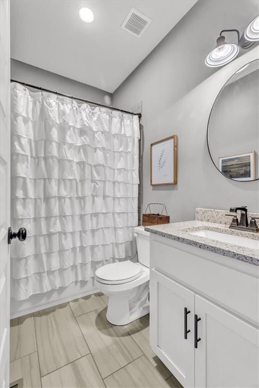 full bathroom with vanity, toilet, and shower / bath combo