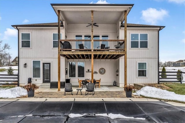 rear view of property featuring a balcony, a patio, and ceiling fan