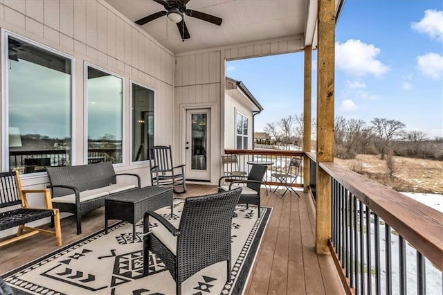 deck with outdoor lounge area and ceiling fan