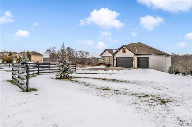 snowy yard featuring a garage