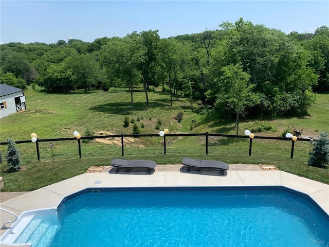 view of pool with a lawn