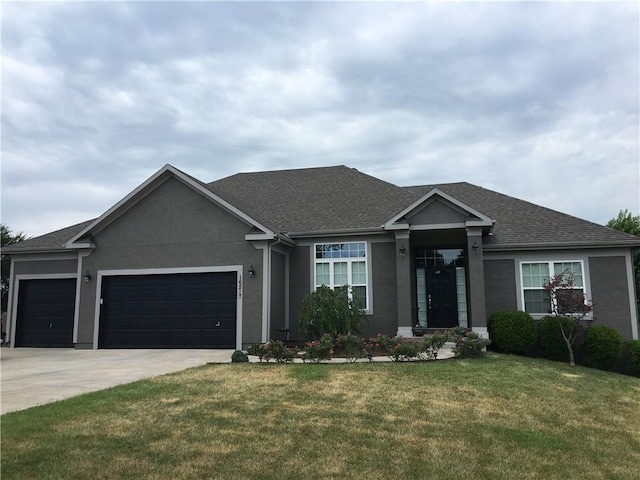 view of front facade with a garage and a front yard