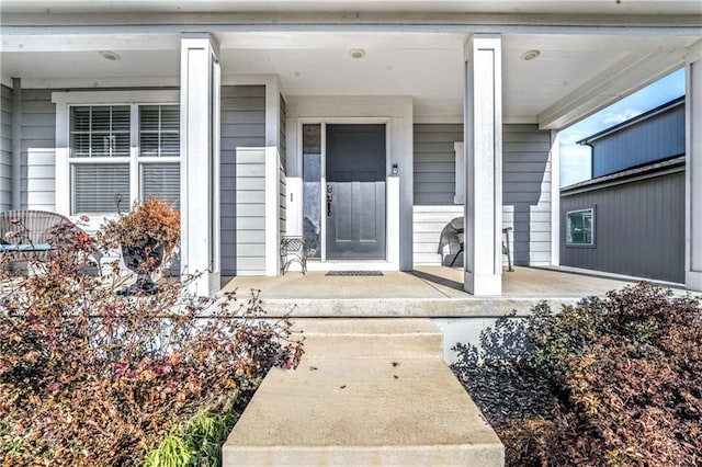 doorway to property featuring covered porch