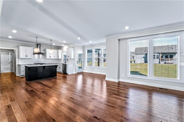 unfurnished living room featuring dark hardwood / wood-style flooring and a wealth of natural light