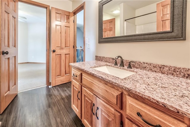 bathroom with hardwood / wood-style flooring and vanity