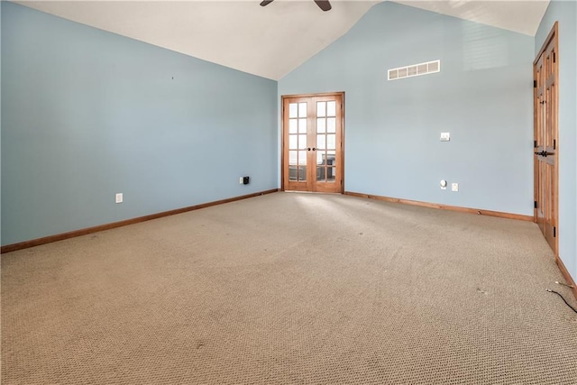 unfurnished room with light carpet, high vaulted ceiling, ceiling fan, and french doors