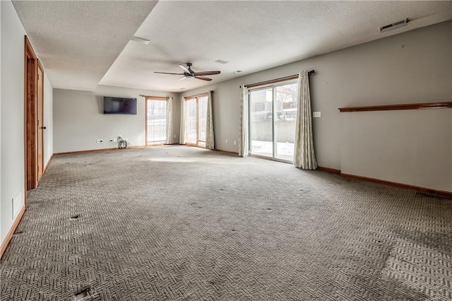 unfurnished living room with ceiling fan, carpet, and a textured ceiling