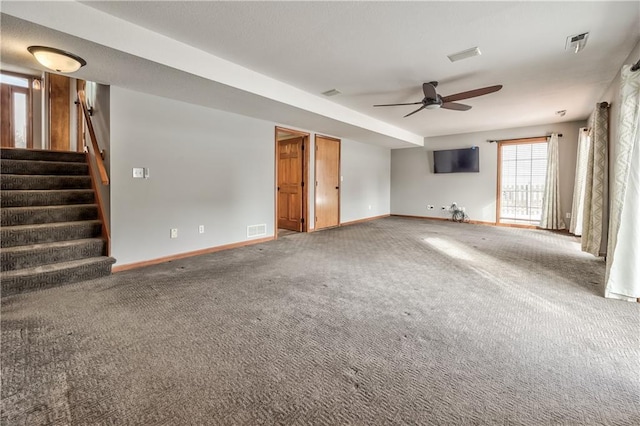 unfurnished living room featuring ceiling fan and carpet