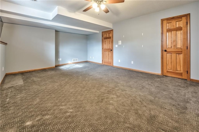 carpeted spare room featuring ceiling fan