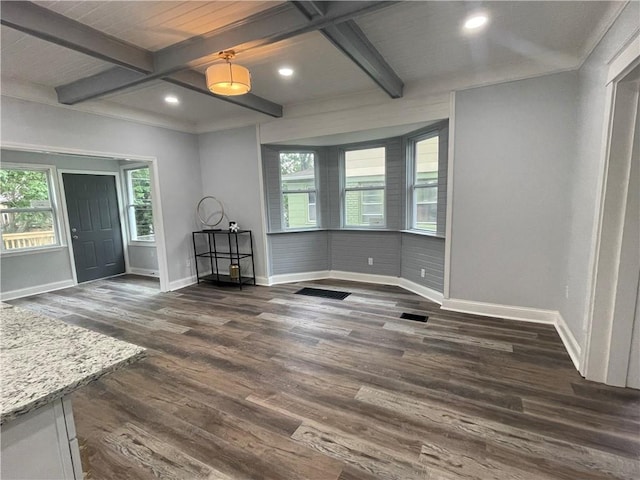 unfurnished dining area featuring beamed ceiling, dark hardwood / wood-style flooring, and coffered ceiling