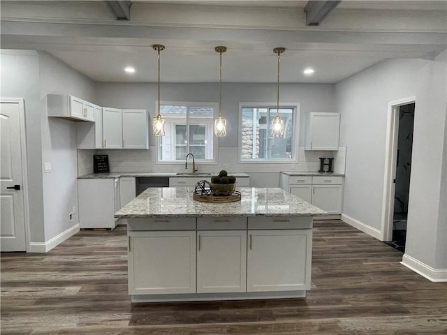 kitchen featuring decorative backsplash, light stone counters, sink, and white cabinets