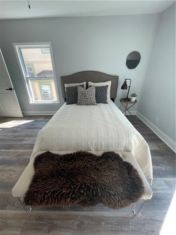 bedroom with dark wood-type flooring