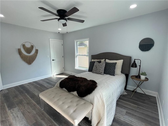 bedroom with ceiling fan and dark hardwood / wood-style flooring