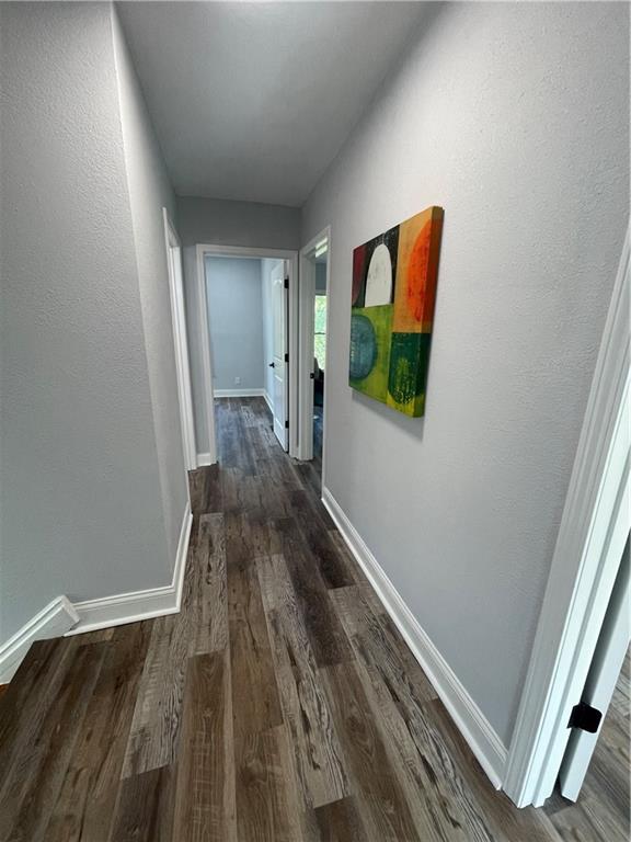 corridor featuring dark wood-type flooring