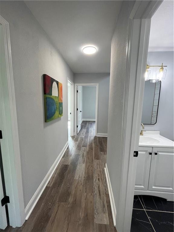 hall with dark hardwood / wood-style flooring and sink