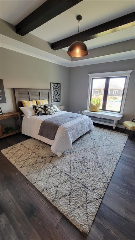 bedroom featuring beam ceiling and dark hardwood / wood-style floors