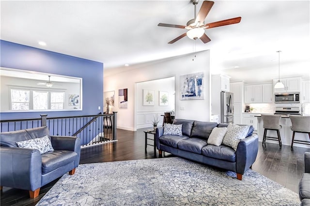 living room featuring dark hardwood / wood-style floors and ceiling fan