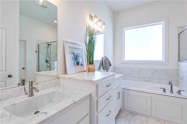 bathroom with vanity and shower with separate bathtub