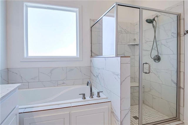 bathroom featuring independent shower and bath and vanity