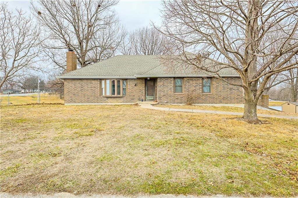 ranch-style house with a front lawn