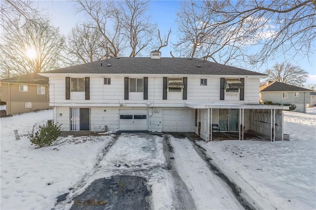 snow covered house with a garage