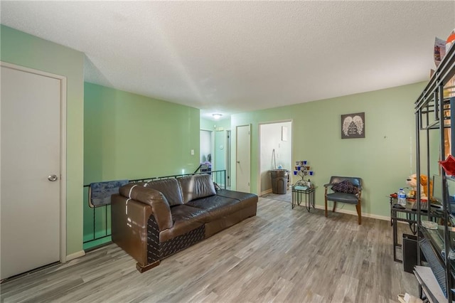 living room featuring a textured ceiling and light hardwood / wood-style flooring