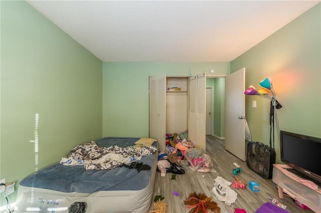 bedroom featuring a closet and light wood-type flooring