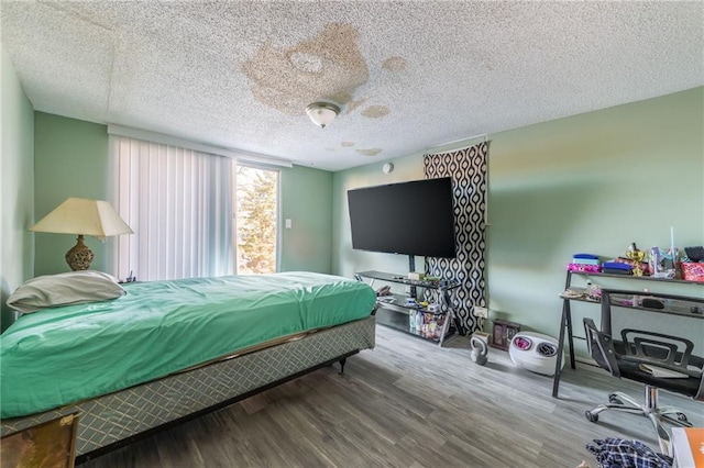 bedroom featuring hardwood / wood-style flooring and a textured ceiling