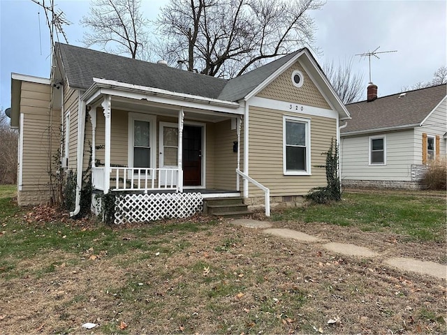 view of front of house with covered porch and a front lawn