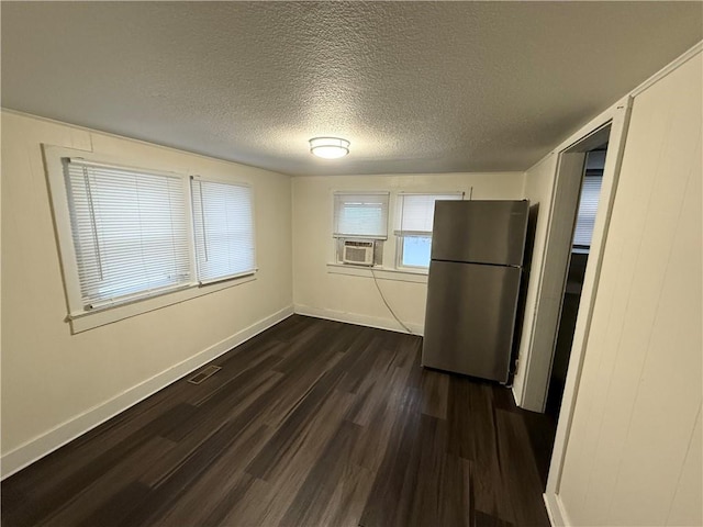 kitchen with stainless steel fridge, cooling unit, dark wood-type flooring, and a textured ceiling