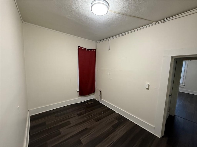 unfurnished room with dark hardwood / wood-style floors and a textured ceiling