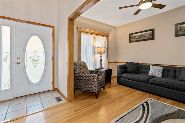 foyer entrance with ceiling fan and hardwood / wood-style flooring