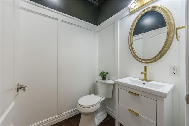 bathroom featuring toilet and vanity