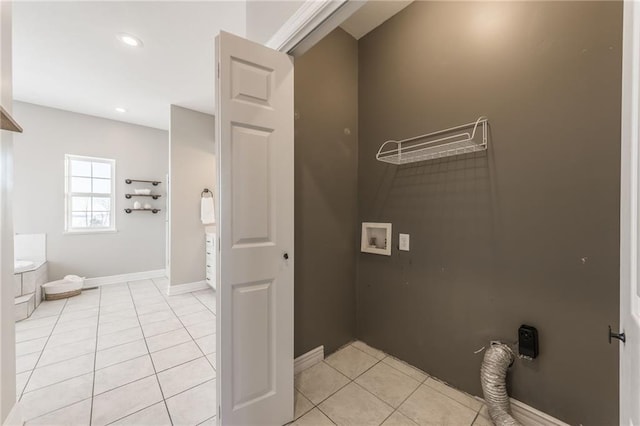 laundry room with hookup for a washing machine and light tile patterned floors