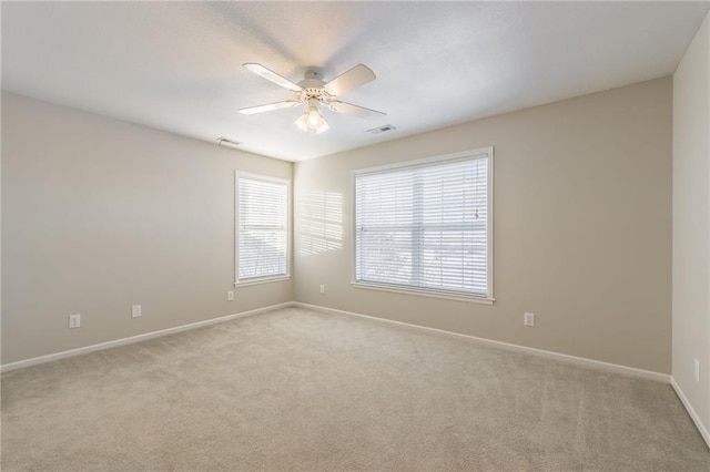 unfurnished room with ceiling fan and light carpet