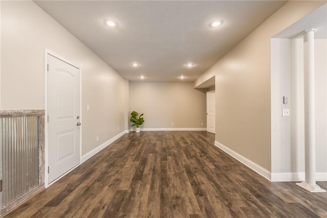 interior space featuring dark hardwood / wood-style flooring and ornate columns