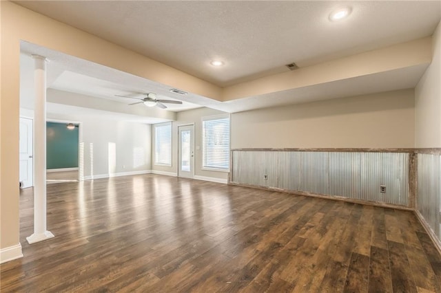 empty room with ceiling fan and dark hardwood / wood-style floors