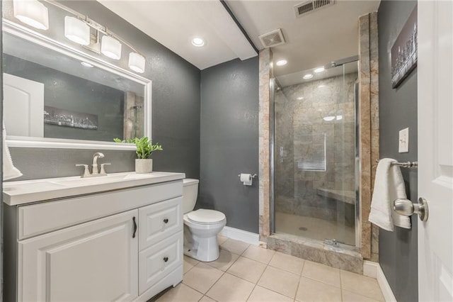 bathroom featuring a shower with door, tile patterned flooring, vanity, and toilet