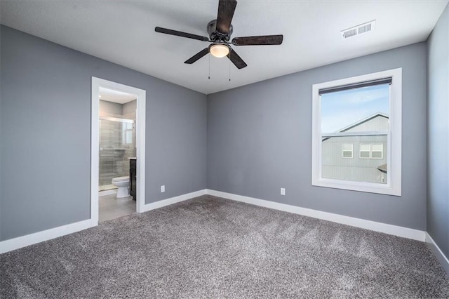 carpeted spare room featuring ceiling fan