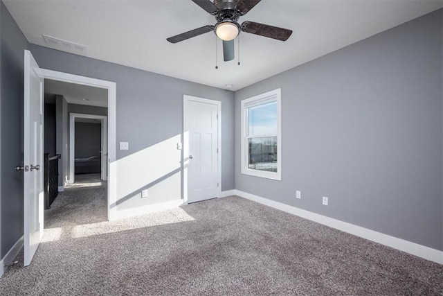 unfurnished bedroom featuring ceiling fan and carpet